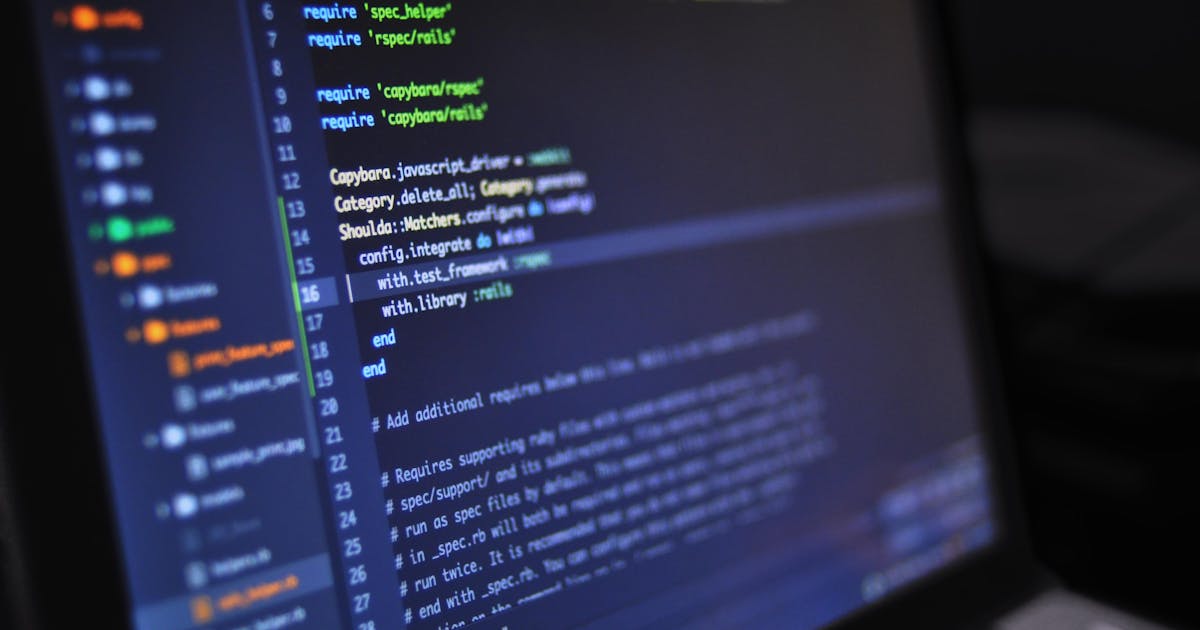 Vibe coding developer war - programming code on laptop screen representing AI-powered coding tools