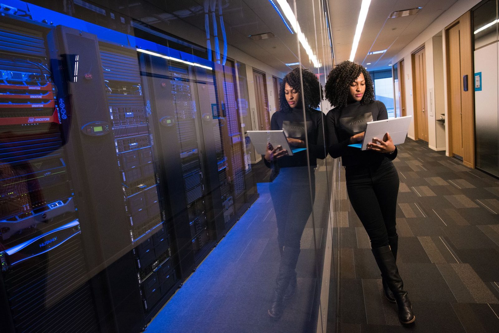 corporate cybersecurity server room engineer with laptop...