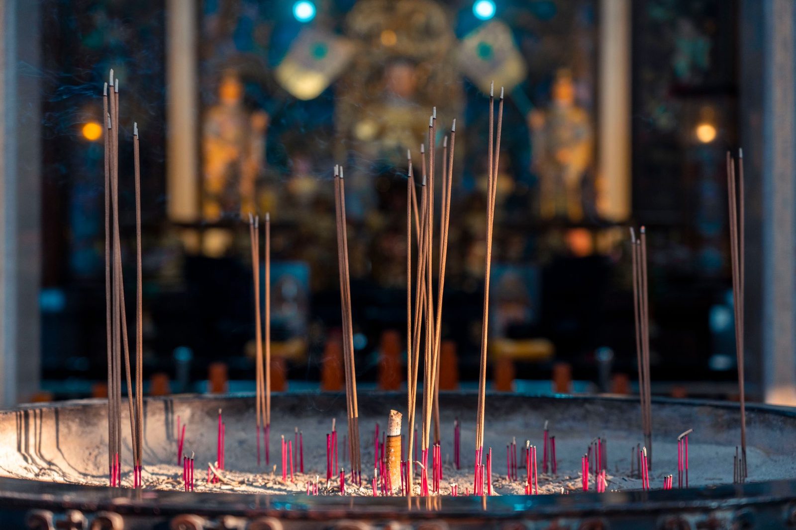 lit candles and incense on a temple altar warm glow...