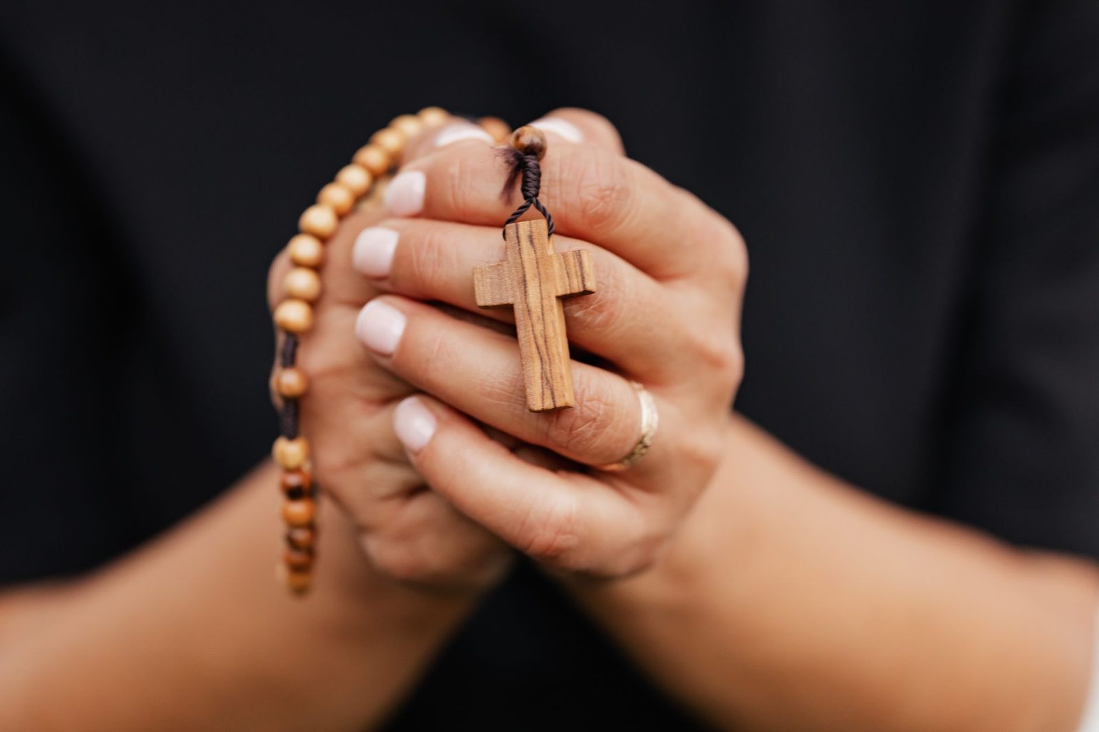 elderly hands holding worn prayer beads faith devotion...
