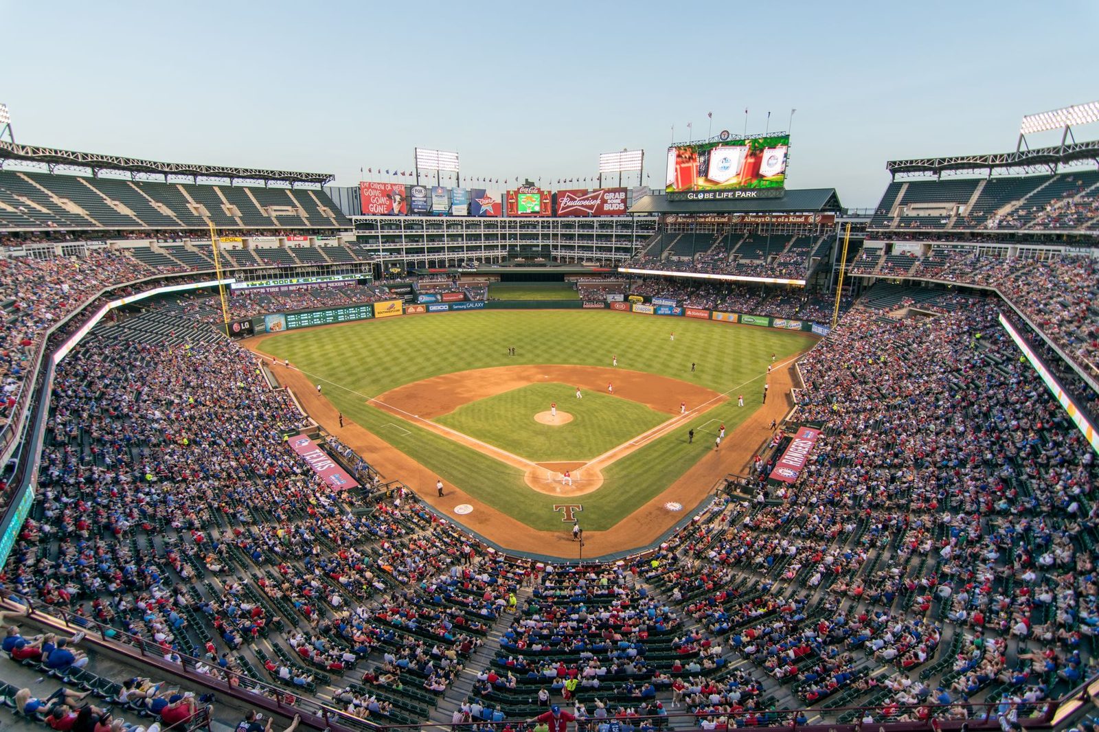 packed baseball stadium crowd cheering night game...