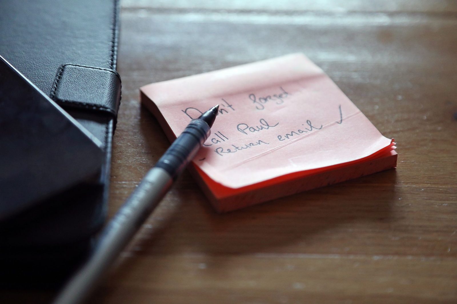 handwritten notebook checklist pen wooden desk planning...