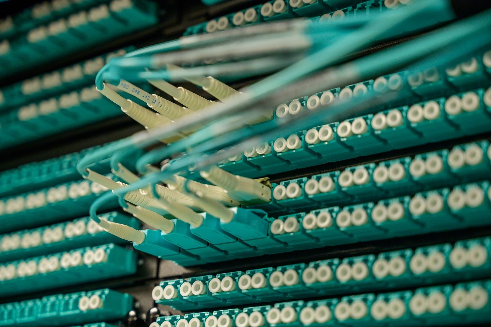 rows of illuminated server racks in a large data center...
