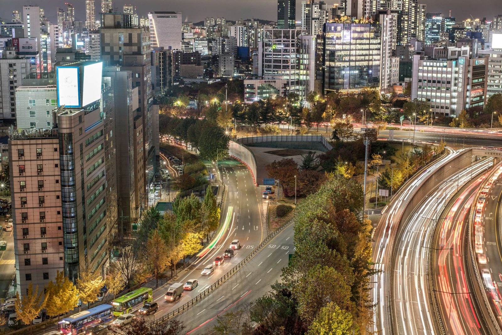 Seoul business district office towers at dusk with light...