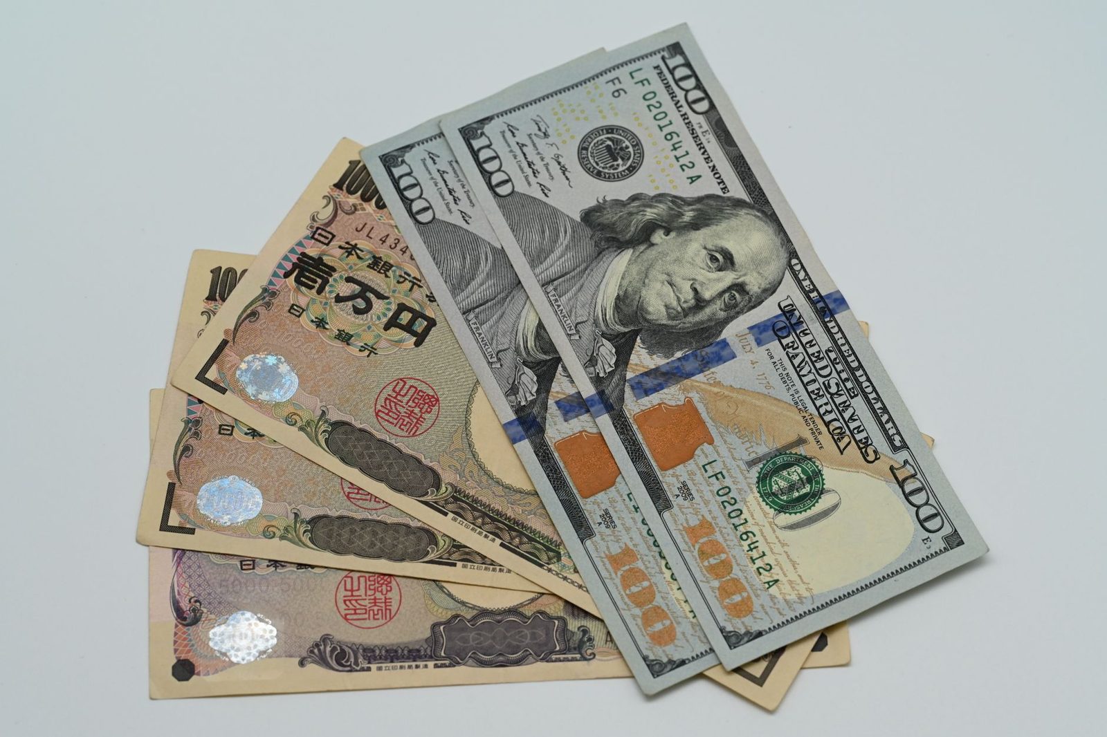 Japanese yen and US dollar banknotes fanned out, representing the US-Japan currency intervention